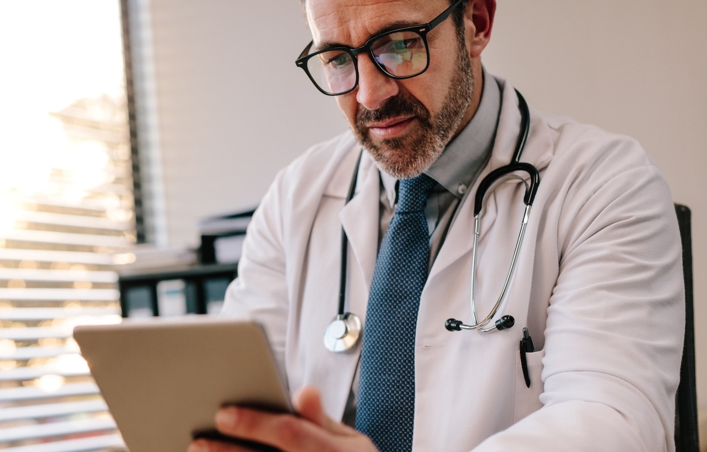 Physician using tablet.